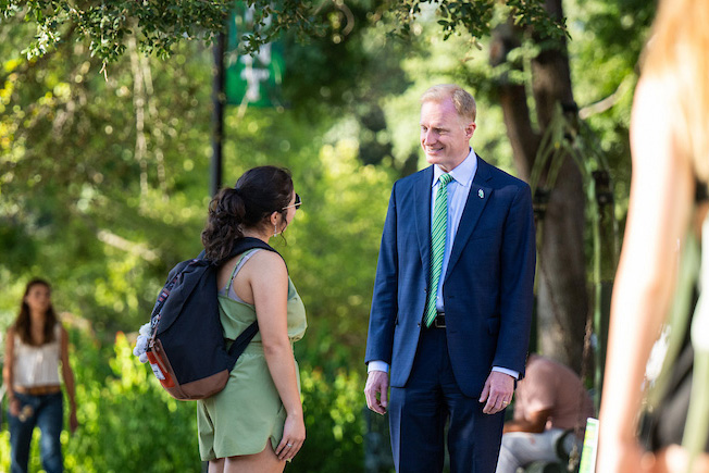 President Keller speaking with a student on campus